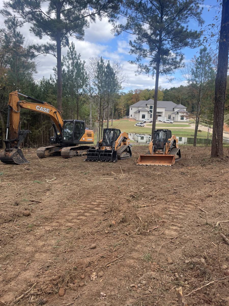 Clearing a wooded lot with an excavator and track loaders