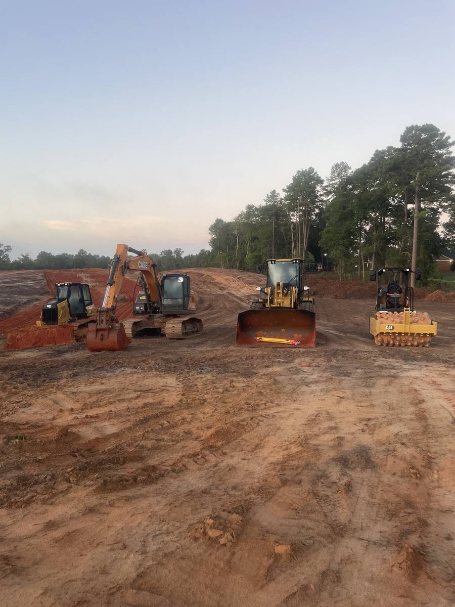 Excavators, a dozer and a roller parked up on site